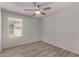 This bedroom features wood look flooring and a ceiling fan for added comfort at 5621 S 30Th Gln, Phoenix, AZ 85041