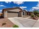 Attractive home showcasing a well-maintained yard, two-car garage, and classic desert architecture at 5621 S 30Th Gln, Phoenix, AZ 85041