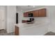Well-equipped kitchen featuring a quartz countertop, stainless steel sink, and ample cabinet space at 5621 S 30Th Gln, Phoenix, AZ 85041