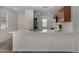 Modern kitchen with a breakfast bar, stainless steel appliances, and stylish tile backsplash at 5621 S 30Th Gln, Phoenix, AZ 85041