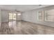 Spacious living room boasts sleek tile floors, a ceiling fan, and natural light from large windows at 5621 S 30Th Gln, Phoenix, AZ 85041