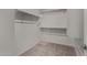 Walk-in closet featuring carpeted flooring and metal shelving units at 5621 S 30Th Gln, Phoenix, AZ 85041