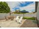 Paver patio with dining and lounging furniture, artificial turf and shade at 620 W Crofton St, Chandler, AZ 85225