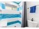 Shower features blue and white tiling, modern shower head and seat at 620 W Crofton St, Chandler, AZ 85225