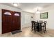 Inviting entryway with a dark wood double door, ceramic tile flooring, and stylish dining area at 620 W Crofton St, Chandler, AZ 85225
