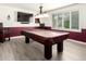 Spacious game room with a large window, a wainscot wall, and a pool table under a three-lamp fixture at 620 W Crofton St, Chandler, AZ 85225