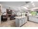 Open-concept kitchen featuring white cabinets, granite countertops, stainless steel appliances, and seamless access to living areas at 620 W Crofton St, Chandler, AZ 85225