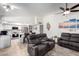 Bright living room connected to the kitchen, featuring modern furnishings, a ceiling fan, and neutral tones at 620 W Crofton St, Chandler, AZ 85225