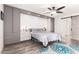 Stylish main bedroom showcasing built-in cabinets, a ceiling fan, and a sliding barn door at 620 W Crofton St, Chandler, AZ 85225