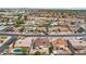Neighborhood aerial of a home with mature trees, several homes with pools, and block wall fencing at 638 W Pantera Ave, Mesa, AZ 85210
