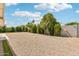 This backyard features rock landscaping and green shrubbery at 638 W Pantera Ave, Mesa, AZ 85210