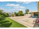 Spacious backyard featuring a rock landscape, a grass area, a patio, and shrubbery at 638 W Pantera Ave, Mesa, AZ 85210