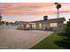 A spacious backyard featuring a patio, rock landscaping, artificial grass, and two palm trees at 638 W Pantera Ave, Mesa, AZ 85210