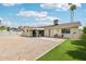 Backyard featuring rock landscape, a patio, a small strip of grass, and palm trees at 638 W Pantera Ave, Mesa, AZ 85210