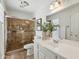 Clean bathroom with a tiled shower, white vanity, and light fixtures at 638 W Pantera Ave, Mesa, AZ 85210