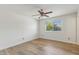 Spacious bedroom with hardwood floors, ceiling fan, and window with backyard view at 638 W Pantera Ave, Mesa, AZ 85210