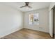 Simple bedroom featuring light hardwood floors, ceiling fan, and natural light from window at 638 W Pantera Ave, Mesa, AZ 85210