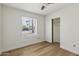 Clean bedroom with hardwood floors, a ceiling fan, closet and a sun-lit window at 638 W Pantera Ave, Mesa, AZ 85210