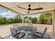 A covered patio featuring a table with four chairs, an overhead fan, and string lights at 638 W Pantera Ave, Mesa, AZ 85210