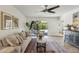 Bright living room with hardwood floors, modern ceiling fan, and sliding glass doors leading to outdoor patio at 638 W Pantera Ave, Mesa, AZ 85210