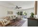 Bright living room with hardwood floors, modern ceiling fan, and sliding glass doors leading to outdoor patio at 638 W Pantera Ave, Mesa, AZ 85210