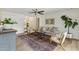 Bright living room with hardwood floors, modern ceiling fan, comfortable furniture, and stylish decor at 638 W Pantera Ave, Mesa, AZ 85210