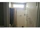 Simple bathroom with a shower, tile walls, and basic fixtures at 6725 W Colter St, Glendale, AZ 85303