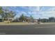 A quaint home exhibits a well-kept lawn, mature trees, and a cozy, inviting curb appeal at 6725 W Colter St, Glendale, AZ 85303