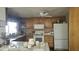 Traditional kitchen featuring wood cabinets, white appliances, tile countertops, and a ceiling fan at 6725 W Colter St, Glendale, AZ 85303