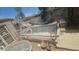 Backyard pool area with aging structure, surrounding hardscape, and partial view of neighboring house at 6725 W Colter St, Glendale, AZ 85303