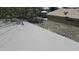 Birds-eye view of a flat roof surface of a home shows backyard with desert landscaping beyond the flat roof at 6725 W Colter St, Glendale, AZ 85303