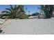 A shingled rooftop with desert landscape and palm trees in view on this home needing repair at 6725 W Colter St, Glendale, AZ 85303
