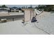 Home rooftop view shows aging shingles, a satellite dish, and block construction needing repair at 6725 W Colter St, Glendale, AZ 85303