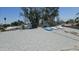 View of aging shingles and a flat roof shows a repair tarp and HVAC on the roof of this home at 6725 W Colter St, Glendale, AZ 85303