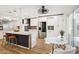 Bright updated kitchen with white cabinetry, stainless appliances, pendant lighting and an island with seating at 7214 N Via De La Siesta --, Scottsdale, AZ 85258
