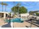 Sparkling community pool with lounge chairs and tables surrounded by lush landscaping and palm trees at 7214 N Via De La Siesta --, Scottsdale, AZ 85258