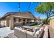Cozy backyard with outdoor seating, string lights, and an artificial grass area with a trampoline at 7634 W Redbird Rd, Peoria, AZ 85383