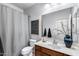 Bathroom with wooden vanity, white countertops, framed mirror and shower with curtain at 7634 W Redbird Rd, Peoria, AZ 85383