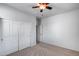 Neutral bedroom with carpet, closet, and ceiling fan; offering a bright and functional space at 7634 W Redbird Rd, Peoria, AZ 85383