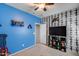 room features carpeted floor, adjacent bath and unique wall-mounted game controller at 7634 W Redbird Rd, Peoria, AZ 85383