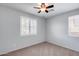 Neutral bedroom with carpeted flooring, a ceiling fan, and a bright window at 7634 W Redbird Rd, Peoria, AZ 85383