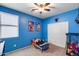bedroom painted with blue walls features carpeted floor, closet and ceiling fan at 7634 W Redbird Rd, Peoria, AZ 85383