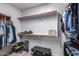 Walk-in closet featuring custom storage and shelves with a variety of shoes and clothing at 7634 W Redbird Rd, Peoria, AZ 85383