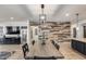 Inviting dining room area with a rustic wood table, decorative wood wall, and modern decor at 7634 W Redbird Rd, Peoria, AZ 85383