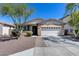 Inviting single-story home with a two-car garage and desert landscaping at 7634 W Redbird Rd, Peoria, AZ 85383