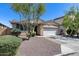 Charming single-story home featuring a well-maintained front yard, two-car garage, and desert landscaping at 7634 W Redbird Rd, Peoria, AZ 85383