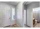 Entryway featuring tiled flooring with natural light from a window and access to a full bath at 7634 W Redbird Rd, Peoria, AZ 85383