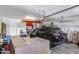 Garage featuring a black SUV, boxes and water toys at 7634 W Redbird Rd, Peoria, AZ 85383