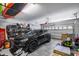 View of the garage featuring a black SUV parked inside with gear for activities at 7634 W Redbird Rd, Peoria, AZ 85383