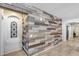 Hallway featuring decorative wood paneling and adjacent arched doorway and closet at 7634 W Redbird Rd, Peoria, AZ 85383